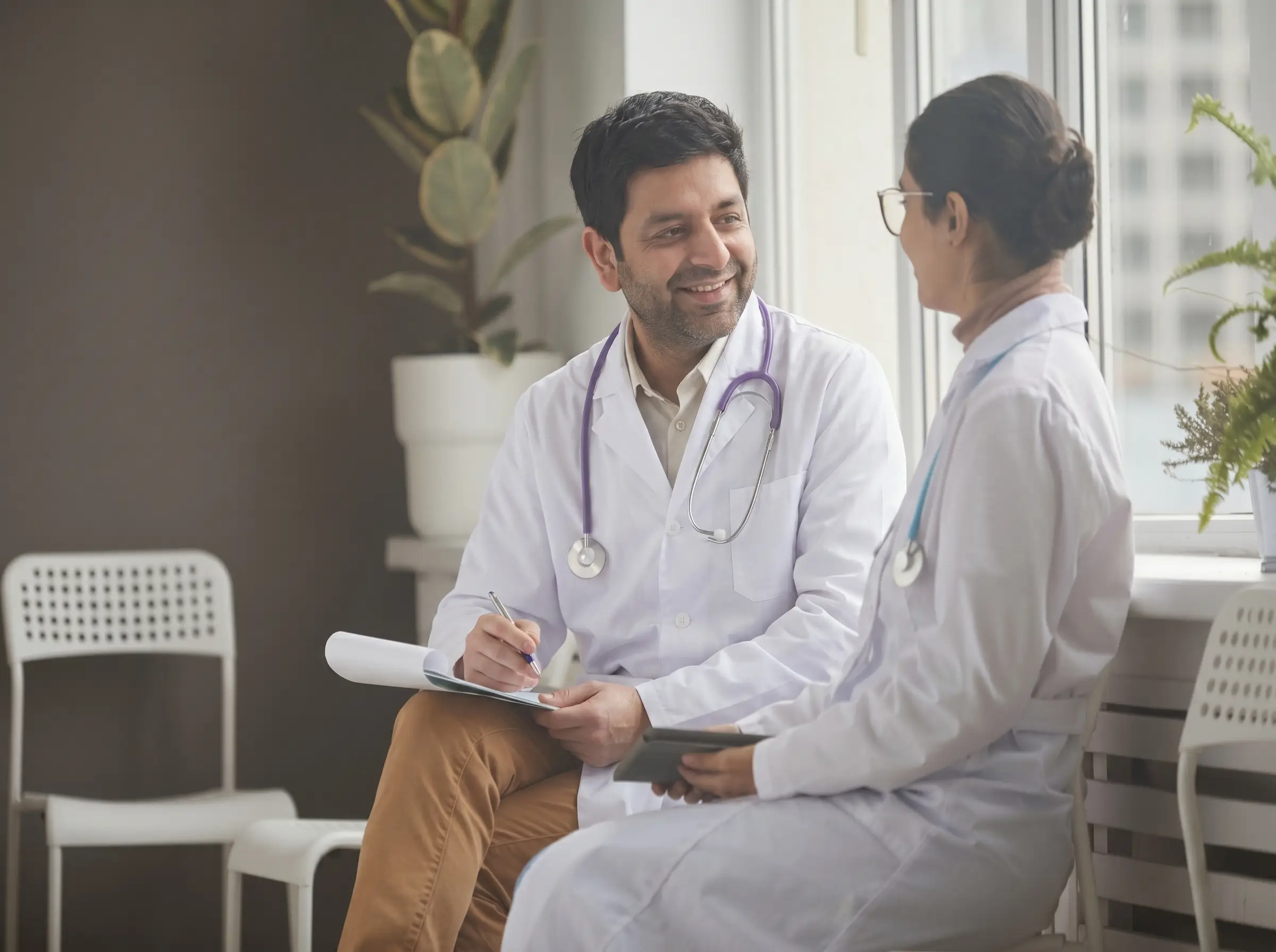 Dr. Sameer sitting with lady doctor